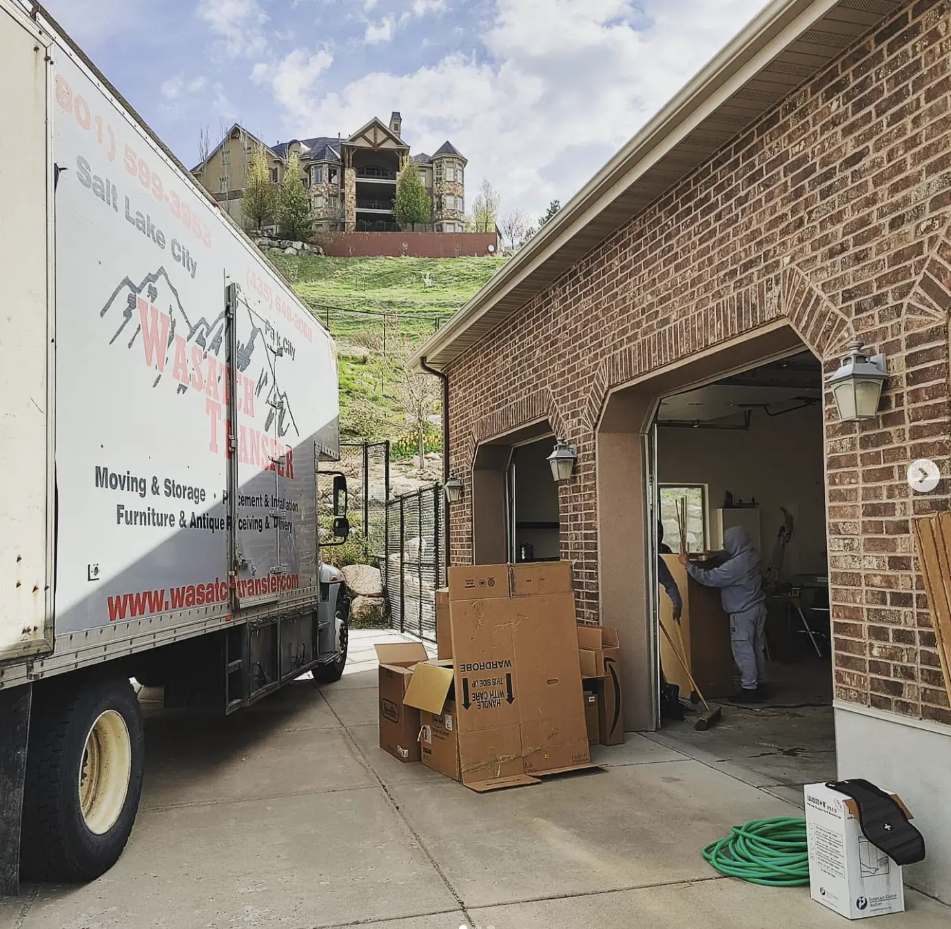 Wasatch Transfer truck and boxes outside a home for residential moving in Salt Lake City
